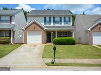 Charming two-story home features a brick facade, attached garage, and a well-maintained front lawn at 4511 Ravenwood Pl # 70, Union City, GA 30291