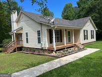 Charming home with a welcoming front porch and well-maintained landscaping at 3725 Concord Rd, Newborn, GA 30056