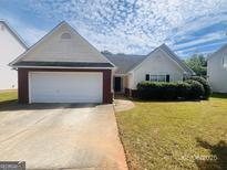 Charming home with a well-maintained lawn and attached garage, perfect for suburban living at 6190 Winston Trce, Mcdonough, GA 30252