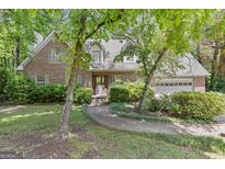 Charming brick home with manicured landscaping and inviting walkway to the entrance at 886 Pine Needle Rd, Hampton, GA 30228