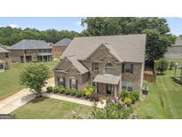 Beautiful brick two-story home with manicured landscaping in a desirable neighborhood at 162 Aylesbury Blvd, Mcdonough, GA 30252