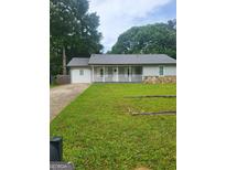 Charming single-story home with a well-manicured lawn and welcoming front porch at 324 Cynthia Ct, Jonesboro, GA 30238