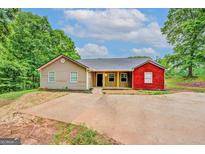 Charming single-story home with a mix of vinyl and brick siding and a spacious front yard at 126 Usher Ln, Covington, GA 30016