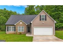 Charming single-Gathering home with stone accents, a well-manicured lawn, and a two-car garage at 416 Clarion Dr, Carrollton, GA 30116
