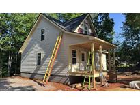 Exterior view of a home under construction showing siding, windows, porch framing and construction materials at 509 Tree Rdg, Carrollton, GA 30116
