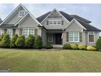 Charming gray brick home with inviting front yard and patriotic American flag at 312 Archway Ln, Peachtree City, GA 30269