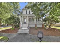 Charming two-story home with a welcoming front porch, landscaped yard, and black shutters at 100 Concord Ct, Fayetteville, GA 30214