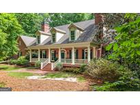 Charming brick home with a welcoming front porch and manicured landscaping at 9274 Betony Wood Trl, Jonesboro, GA 30236