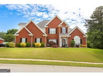 Beautiful two-story brick home featuring a well-manicured lawn and traditional architectural details at 208 Summer Chase, Carrollton, GA 30116