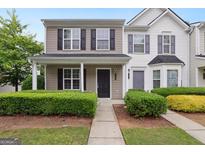 Charming townhome featuring a welcoming porch, well-maintained landscaping, and a classic, inviting facade at 1823 Devon Sw Dr, Atlanta, GA 30311