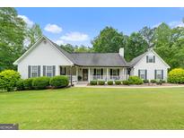 Charming home with a covered front porch and meticulously manicured lawn at 480 Holly Hills Ln, Mcdonough, GA 30252