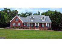 Charming red brick home boasts a lush lawn and mature landscaping at 1118 Sequoia Trl, Mcdonough, GA 30252