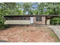 Modest single-story home with a carport and a partially brick facade at 6109 Oakwood Sw Cir, Covington, GA 30014