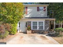 Charming two-story home featuring brick accents, neutral siding, and a well-maintained front yard at 3652 Platina Park Ct, Decatur, GA 30034