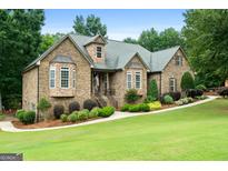 Charming single-Gathering home with brick and stone exterior, manicured lawn, and inviting entrance at 124 Belford Way, Locust Grove, GA 30248