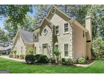 Elegant two-story home with manicured lawn and classic stucco and brick facade at 121 Tamerlane, Peachtree City, GA 30269