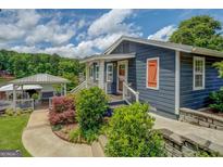 Charming home with a covered outdoor seating area and attractive landscaping at 22 Waters Bridge Cir, Covington, GA 30014