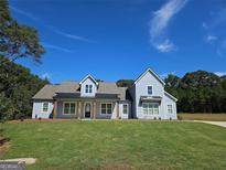 Charming two-story home with a well-manicured lawn under a bright, clear sky at 1685 Crumbley Rd # 4, Mcdonough, GA 30252