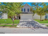 Charming two-story home featuring a well-maintained lawn and a two-car garage at 9151 Jefferson Village Sw Dr, Covington, GA 30014