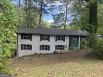 Two-story house with gray brick, black shutters, and a well-shaded front yard at 2851 Headland Dr, East Point, GA 30344