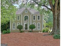 Traditional two-story home boasting well-manicured landscaping and classic architectural details at 112 Windalier Rdg, Peachtree City, GA 30269