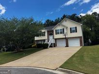 Charming two-story home with a two-car garage and a well-maintained lawn at 851 Walkingstick Dr, Douglasville, GA 30134