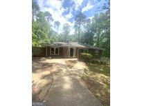Charming brick home featuring a well-maintained front yard and driveway with mature trees providing ample shade at 288 Harper Se Rd, Atlanta, GA 30315