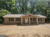 Charming single-story home with a metal roof and a welcoming front porch at 367 Frashier Rd, Carrollton, GA 30116