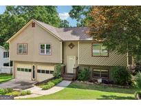 Charming home featuring a two-car garage, complemented by a beautifully landscaped front yard at 2958 Cordite Loop, Snellville, GA 30039