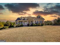 Inviting single-Gathering home with manicured lawn, lovely front porch, and warm curb appeal at 4180 Mount Paran Dr, Social Circle, GA 30025