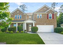 Charming brick home featuring a well-manicured lawn, two-car garage and inviting front porch at 6533 Waterford Sw St, Atlanta, GA 30331