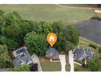 Stunning aerial view of a beautiful home with a pool, golf course, and lake access at 5028 Chapel Lake Cir, Douglasville, GA 30135