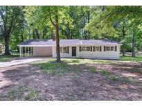 Charming single-story home featuring a covered carport and mature trees at 37 S Forty Pass W, Hiram, GA 30141