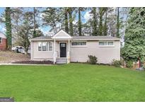 Charming single-story home with a well-manicured lawn and classic brick exterior at 3317 Renault Se Rd, Atlanta, GA 30354