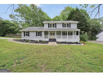 Charming two-story home with a inviting front porch and well-manicured lawn at 3440 Concord Se Cor, Conyers, GA 30013