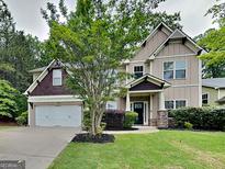 Charming two-story home features a well-manicured lawn, a two car garage, and inviting front entrance at 330 Bentleigh Station Dr, Acworth, GA 30101