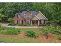 Charming brick home with black shutters, mature landscaping, and a circular driveway at 30 Joe Lee Dr, Sharpsburg, GA 30277