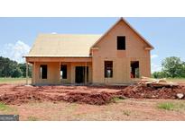 Unfinished home featuring a gable roof, window openings, and a partially covered front porch at 242 Old Jackson Rd, Mcdonough, GA 30252