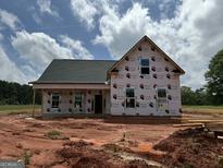 New construction home featuring a gabled roof, covered porch, and windows installed at 242 Old Jackson Rd, Mcdonough, GA 30252