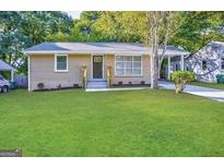 Charming single-story brick home featuring a well-manicured lawn and welcoming front entrance at 2851 Mitchell Dr, Decatur, GA 30032