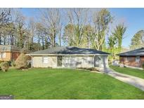 Charming one-story home with a well-maintained lawn and a paved driveway at 2215 Rosewood Rd, Decatur, GA 30032