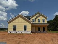 New two-story home featuring board and batten siding and black roof at 1916 King Mill Rd, Mcdonough, GA 30252