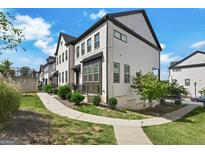 Charming townhome featuring a modern exterior, well-manicured lawn, and inviting curb appeal on a sunny day at 4760 Highside Way, Smyrna, GA 30082