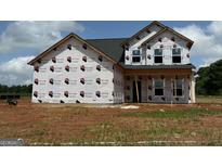 New construction home featuring architectural details awaiting finishing touches, including large windows at 1936 King Mill Rd, Mcdonough, GA 30252