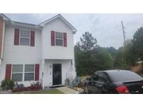 Charming townhouse with a cozy front porch and well-maintained exterior at 6880 Mountain Cir, Riverdale, GA 30274