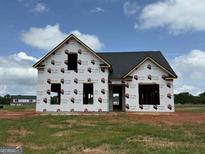 Image of a new home under construction showing windows and dark roof at 1926 King Mill Rd, Mcdonough, GA 30252
