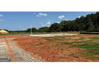 New home construction site with a concrete foundation ready for building the new home at 1926 King Mill Rd, Mcdonough, GA 30252