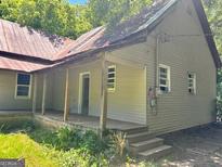 A quaint home with a classic design and a welcoming porch, perfect for relaxing outdoors at 585 Huddleston Rd, Fayetteville, GA 30214