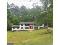 Charming exterior of home with a bright red front door and well-maintained landscaping at 3132 Riders Trl, Decatur, GA 30034