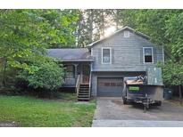 Charming two-story home with attached garage and partially wooded lot at 4060 Sumit Wood Nw Dr, Kennesaw, GA 30152